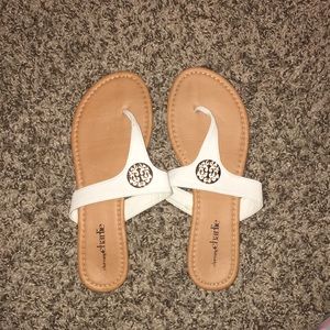 White and gold flip flops